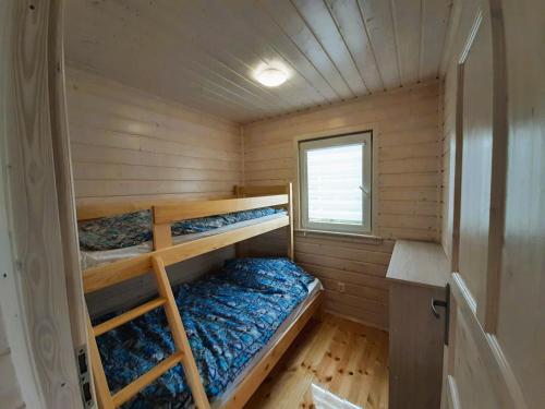 a small cabin with two bunk beds in it at Na Wydmie in Wicie