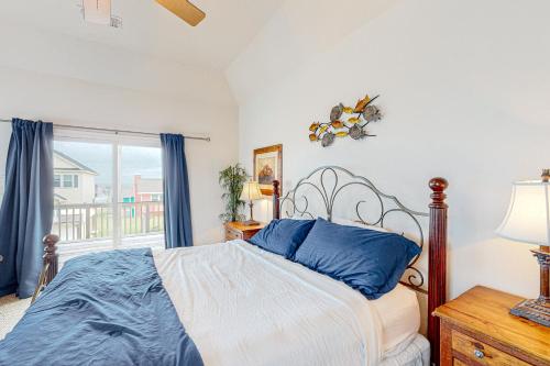 a bedroom with a bed and a window at Sea Breeze in Galveston