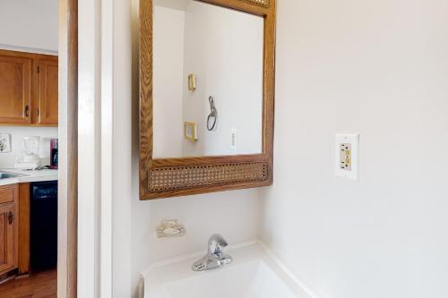 a bathroom with a sink and a mirror at The Coral Starfish #10J in Ocean City