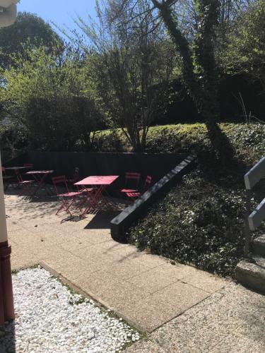 a picnic table and chairs in a park at Hotel Inn Design Le Havre in Montivilliers
