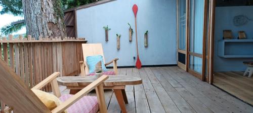 a patio with a table and chairs and a tree at Tribal Green Camp Private Room 1 in Santana