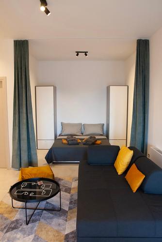 a living room with a couch and a bed at Villa d'Anvers - Luxury Holiday Resort in Souda