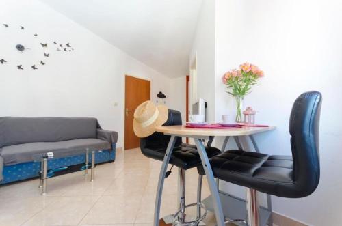 a living room with a table and a couch at Apartment Marija in Vodice