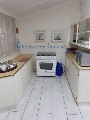 a kitchen with white cabinets and a white stove at 15 President Street in Parys in Parys