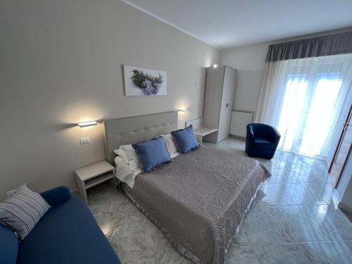 a bedroom with a bed and a blue couch at Innsud in Nardò