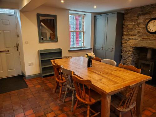 a dining room with a wooden table and chairs at Brackendale in Bala
