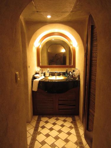a bathroom with a sink and a mirror at Beautiful apartment fully restored after OTIS in Acapulco Diamante in Acapulco