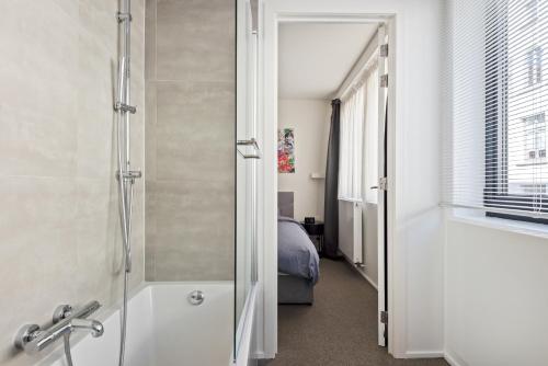 łazienka z prysznicem i sypialnia w obiekcie Ernest 33 w Antwerpii