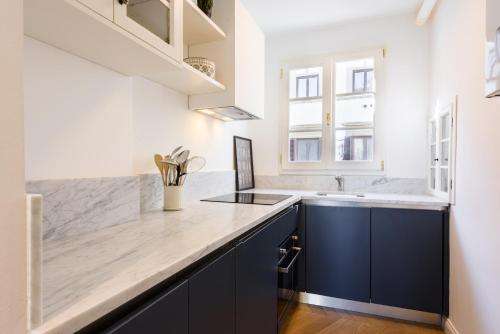 a kitchen with blue cabinets and a counter top at Luxury San Niccolò in Florence