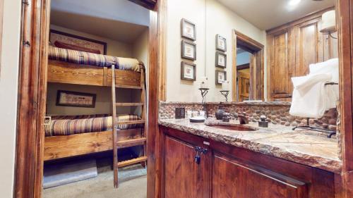 a bathroom with a sink and a large mirror at Snowcreek 269 Condo in Mammoth Lakes
