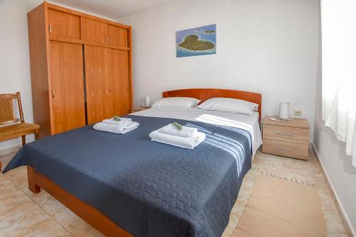 a bedroom with a bed with two towels on it at House Kastel in Tkon