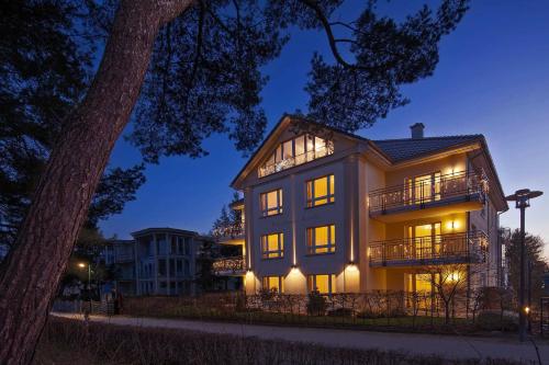 a large house with lights on at night at Strandhaus Aurell in Heringsdorf