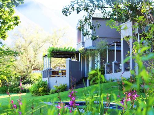 a house with a garden in front of it at Arumvale Country Retreat in Swellendam