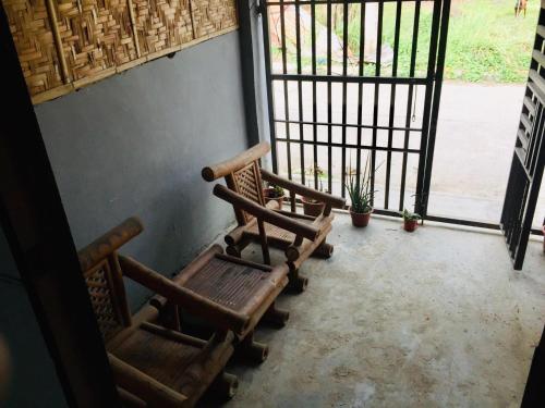 two chairs sitting in front of a door at Aziels BnB in Kabankalan