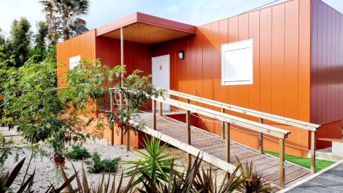 an orange building with a ramp next to it at Family Surf Home - Bungalows in Mafra
