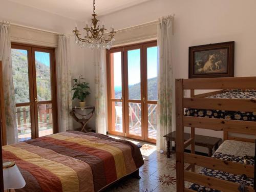 a bedroom with a bed and a large window at La Margherita di Teriasca in Teriasca