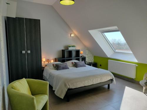 a bedroom with a bed and a chair and a window at Le Clos des Pommiers in Tracy-sur-Mer