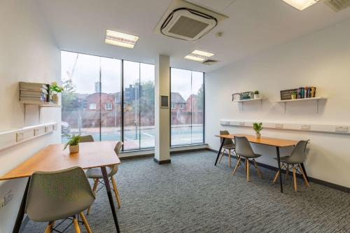 an office with two tables and chairs and a large window at For Students Only Glassworks in Liverpool in Liverpool