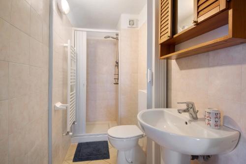 a bathroom with a sink and a toilet and a shower at La Fermenteria in San Colombano Certenoli