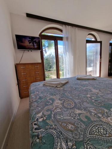 a bedroom with a large bed with a bedspread with a design at Studio apartman Karla in Rijeka