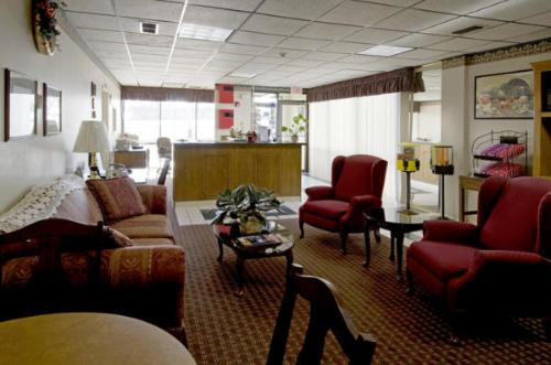 a living room filled with furniture and a large window at Americas Best Value Inn Bowie in Bowie