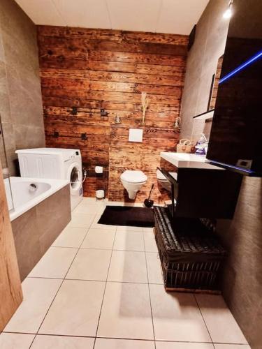a bathroom with a toilet and a sink and a tub at La parenthèse in Marche-en-Famenne