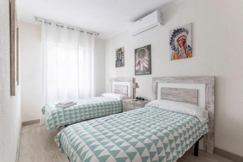 Ένα ή περισσότερα κρεβάτια σε δωμάτιο στο Coqueto y Luminoso en la Playa de La Arena