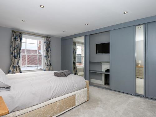 a bedroom with a large bed and a tv at The Eastgate Apartment in Louth