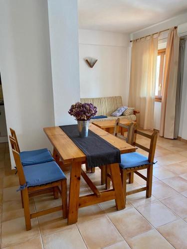 a wooden table and chairs in a living room at Apartamentos Ferrer in Es Figueral Beach