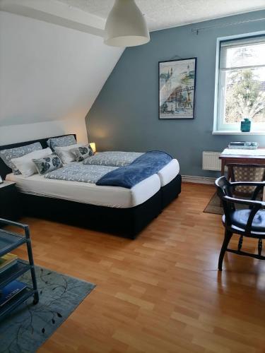 a bedroom with a bed and a blue wall at Gutshaus Dämelow tussen Schwerin en Wismar in Dämelow