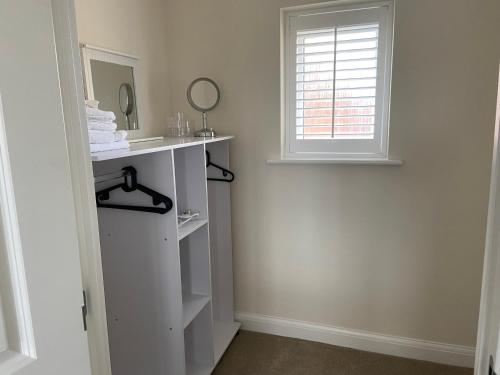 a bathroom with a sink and a window at Westergate - 4 Bed Luxury Home with free parking in Milton Keynes