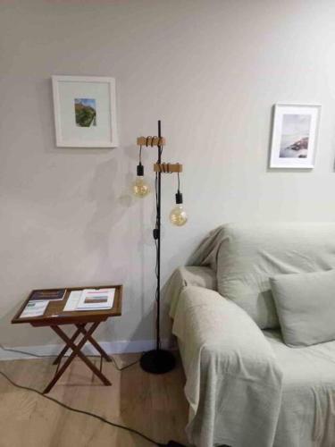 a living room with a couch and a table at Apartamento en Granada de nueva construcción con A/C y WIFI in Armilla