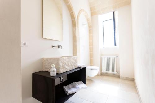 a bathroom with a sink and a toilet at Dimora La Scaledda in Serranova