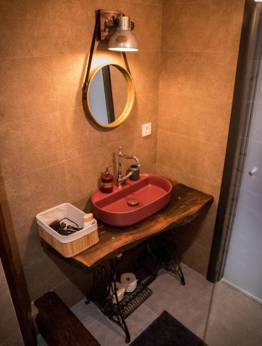 a bathroom with a red sink and a mirror at Čista desetka! - sa garažnim mestom in Novi Sad
