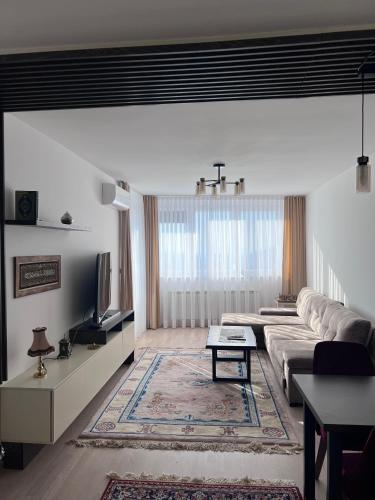 a living room with a couch and a tv at SkyView Apartment in Sarajevo