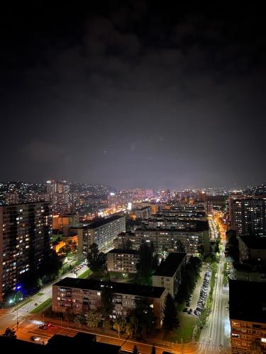 a view of a city at night with lights at SkyView Apartment in Sarajevo
