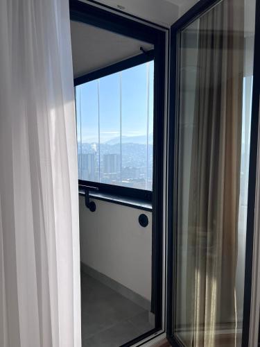 a room with a window with a view of the city at SkyView Apartment in Sarajevo