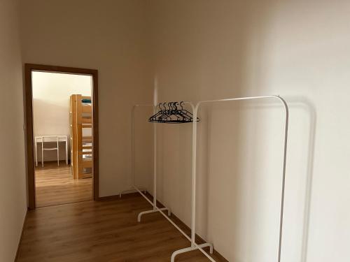 a room with a white wall and a mirror at Brand new apartments and hostel in center in Prague