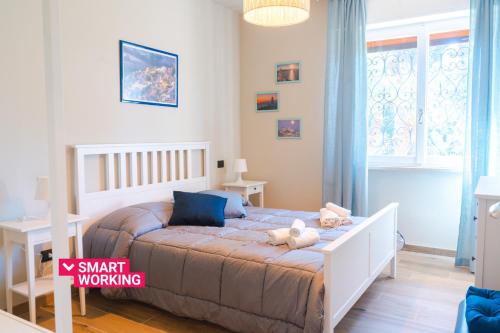 a bedroom with a bed with a teddy bear on it at Lemon Apartment with Garden and Sea View by Wonderful Italy in Bordighera