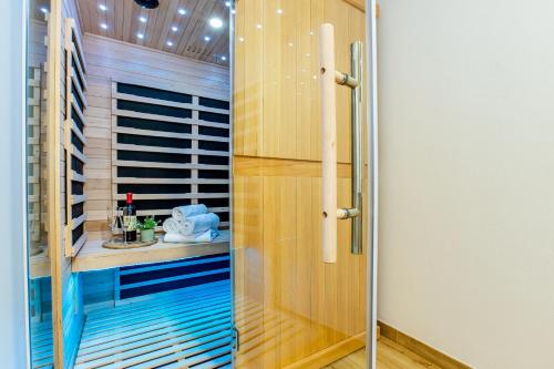 a shower with a glass door in a bathroom at Apartmány Karlovy Dvory in Horní Planá