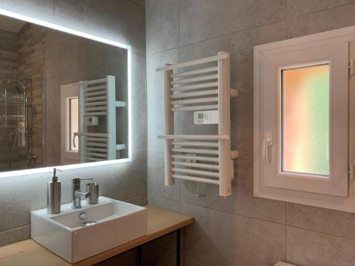 a bathroom with a sink and a mirror at gîte du Cady in Casteil