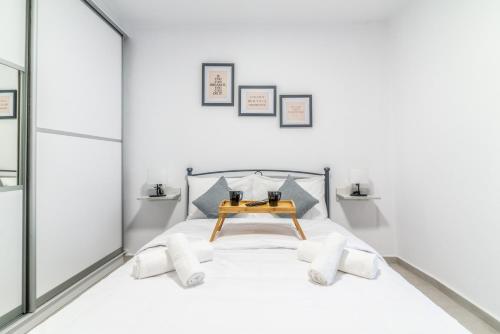 a bedroom with a bed with a table on it at Stylish & relax flat for friends & couples in Heraklio Town