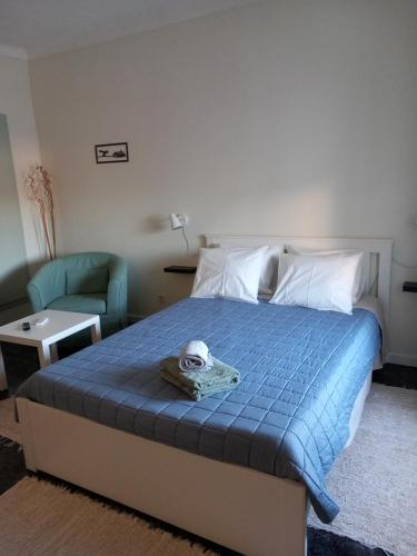 a bedroom with a bed with a stuffed animal on it at Casa Porta do Sol in Estremoz