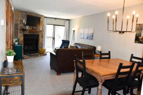 a living room with a table and a couch at Cozy Mountain Getaway! Mountain views! 2 bed, 2 bath, Sleeps 6 in Gatlinburg