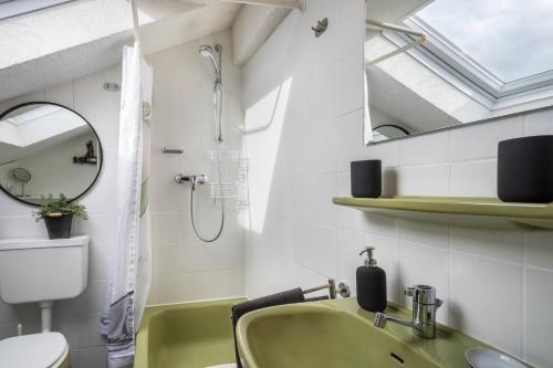 a bathroom with a sink and a toilet and a window at Haus Sonnenhang Wohnung 3 in Stiefenhofen