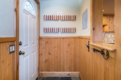 a door to a kitchen with wooden paneled walls at Krystal Villa #5 in Ketchum