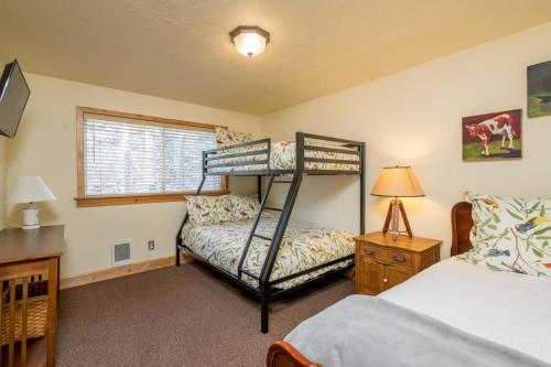a bedroom with two bunk beds and a window at Krystal Villa #5 in Ketchum