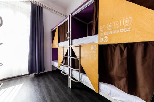 a couple of bunk beds in a dorm room at Adagio Hostel Basilica in Budapest
