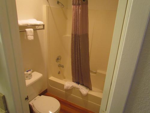 a bathroom with a toilet and a tub and a shower at Motel 6-Vancouver, WA in Vancouver