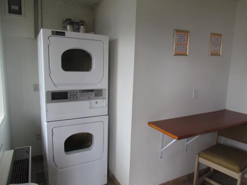 a kitchen with a white oven and a table at Motel 6-Vancouver, WA in Vancouver